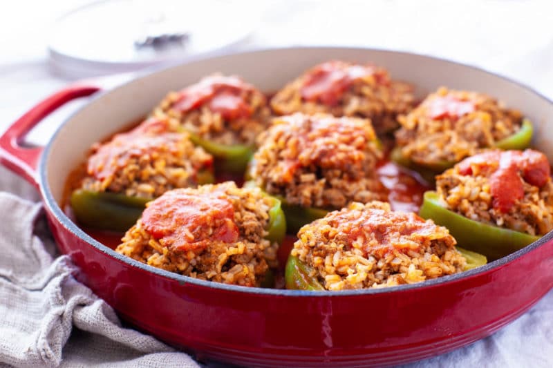 Green bell peppers stuffed with rice and beef in a tomato sauce