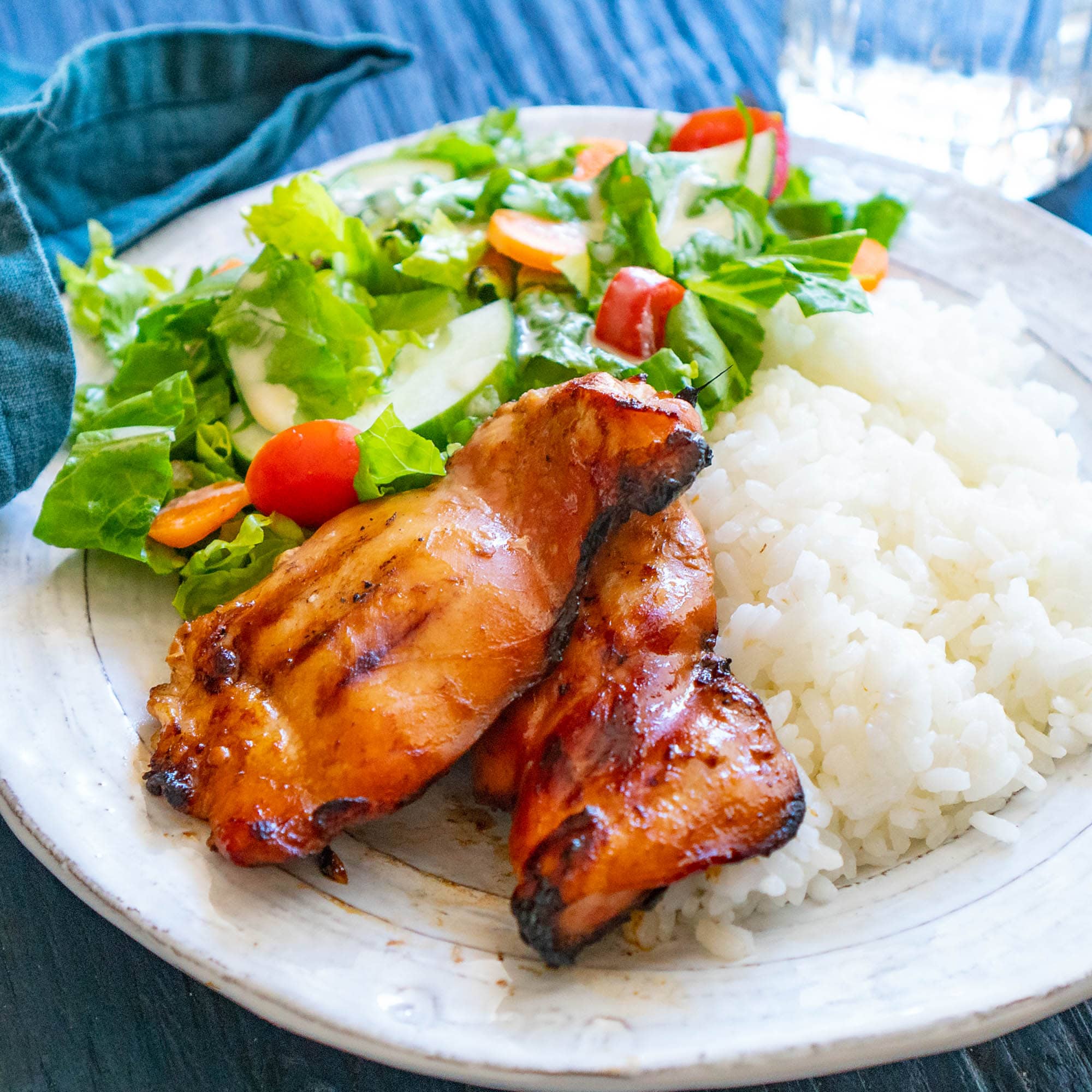 teriyaki chicken on plate with rice and salad