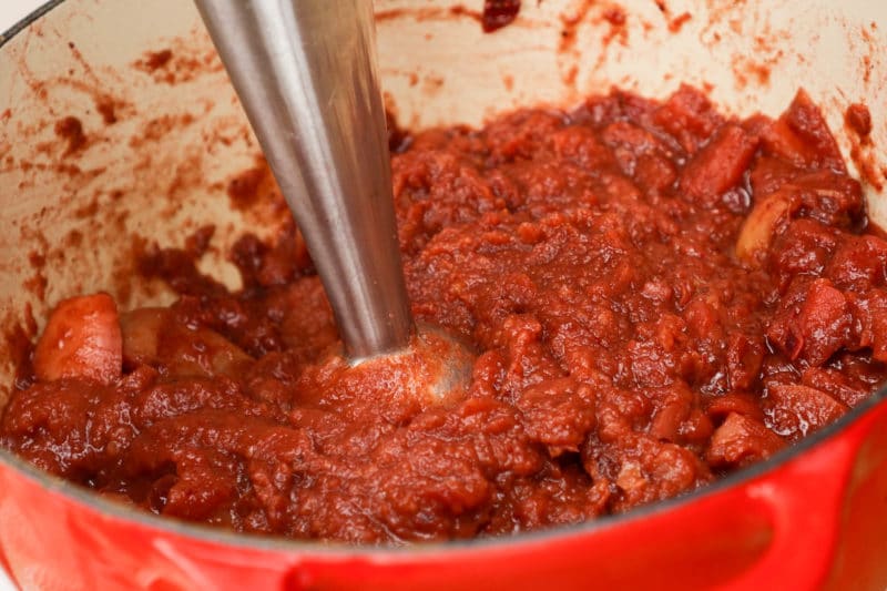 Using an immersion blender to puree cranberry applesauce
