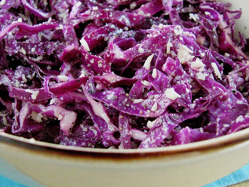 Mixing the cabbage salad in a large bowl.