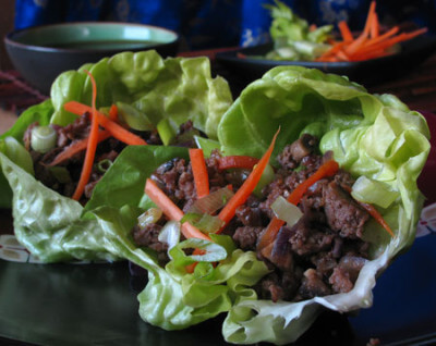 cooked ground beef and vegetables in butter lettuce cups