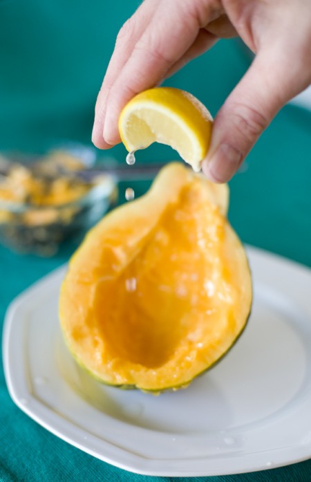 squeezing lemon on papaya