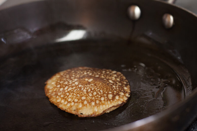 How to make banana pancakes, gluten free, grain free, just eggs cinnamon and bananas. Step by step photos of my toddler making them! From EatingRichly.com