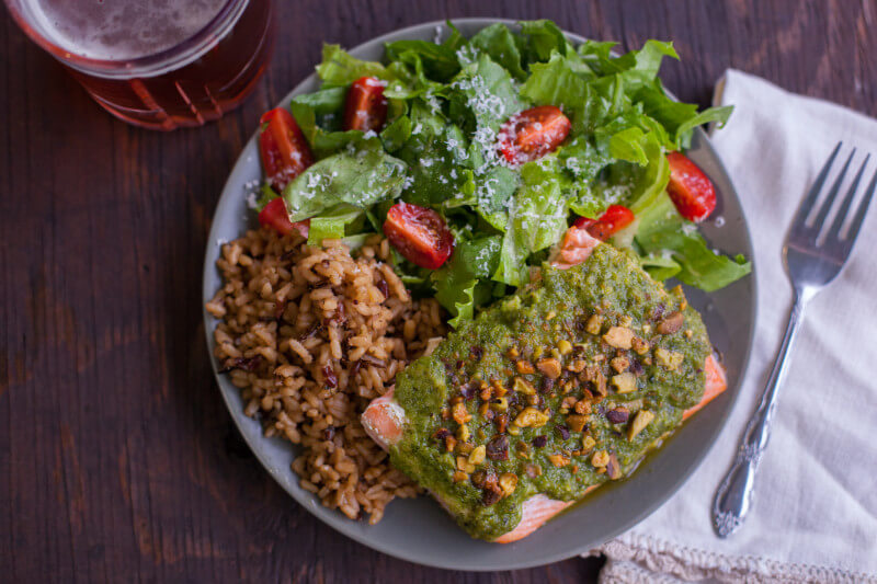 This easy salmon recipe is simple enough for a toddler to make! Kids love the colorful pesto & crunchy pistachios, making it a perfect way to introduce fish to your little ones. Part of #MiniChefMondays on EatingRichly.com
