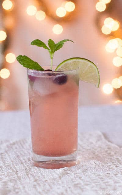 A refreshing mojito mocktail with fresh cranberries and cranberry juice. Check out all 20 booze free Mother's Day drinks on EatingRichly.com