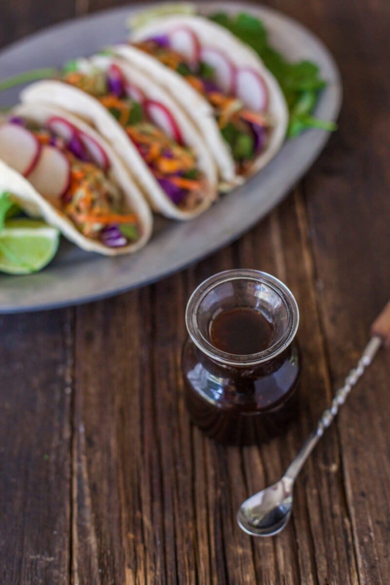 Korean tacos filled with easy flavorful crockpot pulled pork, crunchy veggies, and sweet and spicy sauces. You could start your own food truck with these! From EatingRichly.com