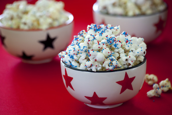 Easy patriotic almond bark popcorn. Get more 4th of July Snacks that kids can make at EatingRichly.com