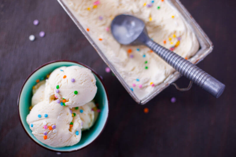 This cake batter ice cream recipe doesn't require any cooking. Simply mix and churn for amazing ice cream that tastes just like birthday cake! From EatingRichly.com