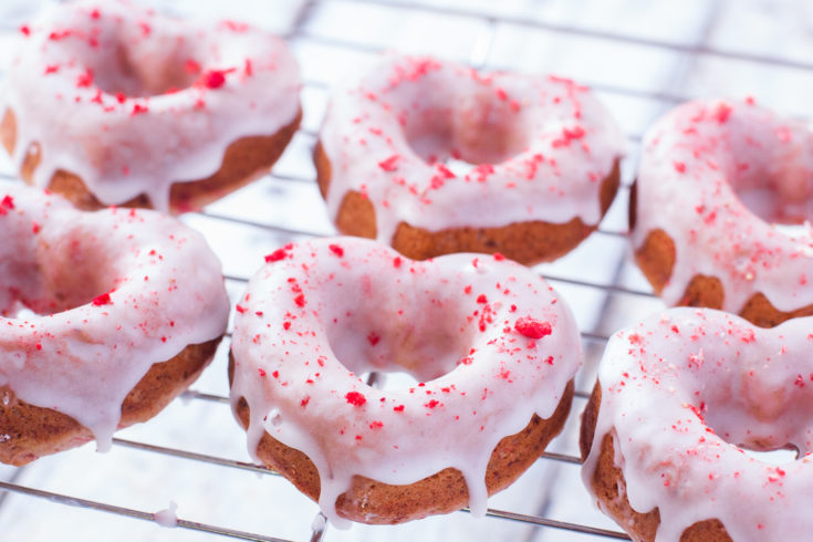 These strawberry sprinkle donut hearts are made with crumbled freeze dried strawberries, and a sweet lemon glaze, for a gorgeous dye free strawberry lemonade treat perfect for Valentine's Day. From EatingRichly.com