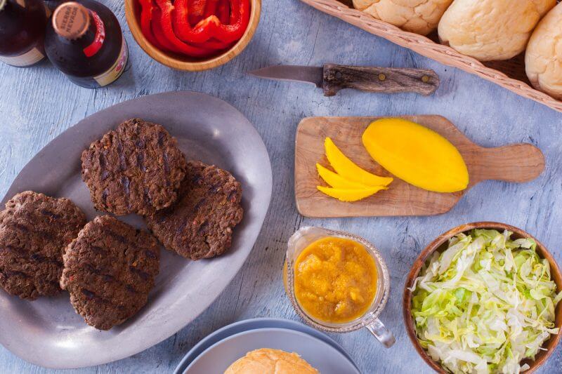 This Jamaican burger recipe will blow your mind! It's a Jamaican jerk seasoned burger topped with spicy pineapple sauce, sweet mango, and red bell pepper. It's the stuff burger dreams are made of! From EatingRichly.com