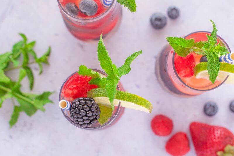 This refreshing summer sangria berry punch is made with Riesling, sparkling wine, summer berries, fresh mint, triple sec, & lime. Perfect for backyard parties! From EatingRichly.com