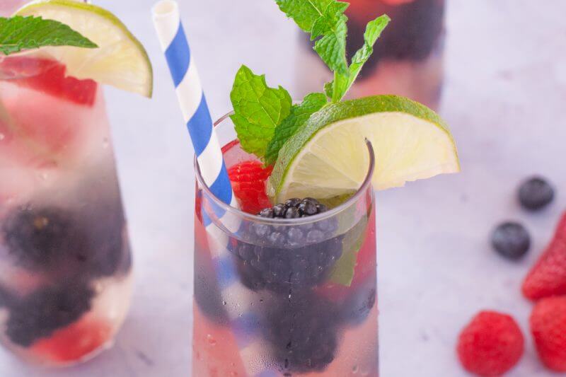 This refreshing summer sangria berry punch is made with Riesling, sparkling wine, summer berries, fresh mint, triple sec, & lime. Perfect for backyard parties! From EatingRichly.com