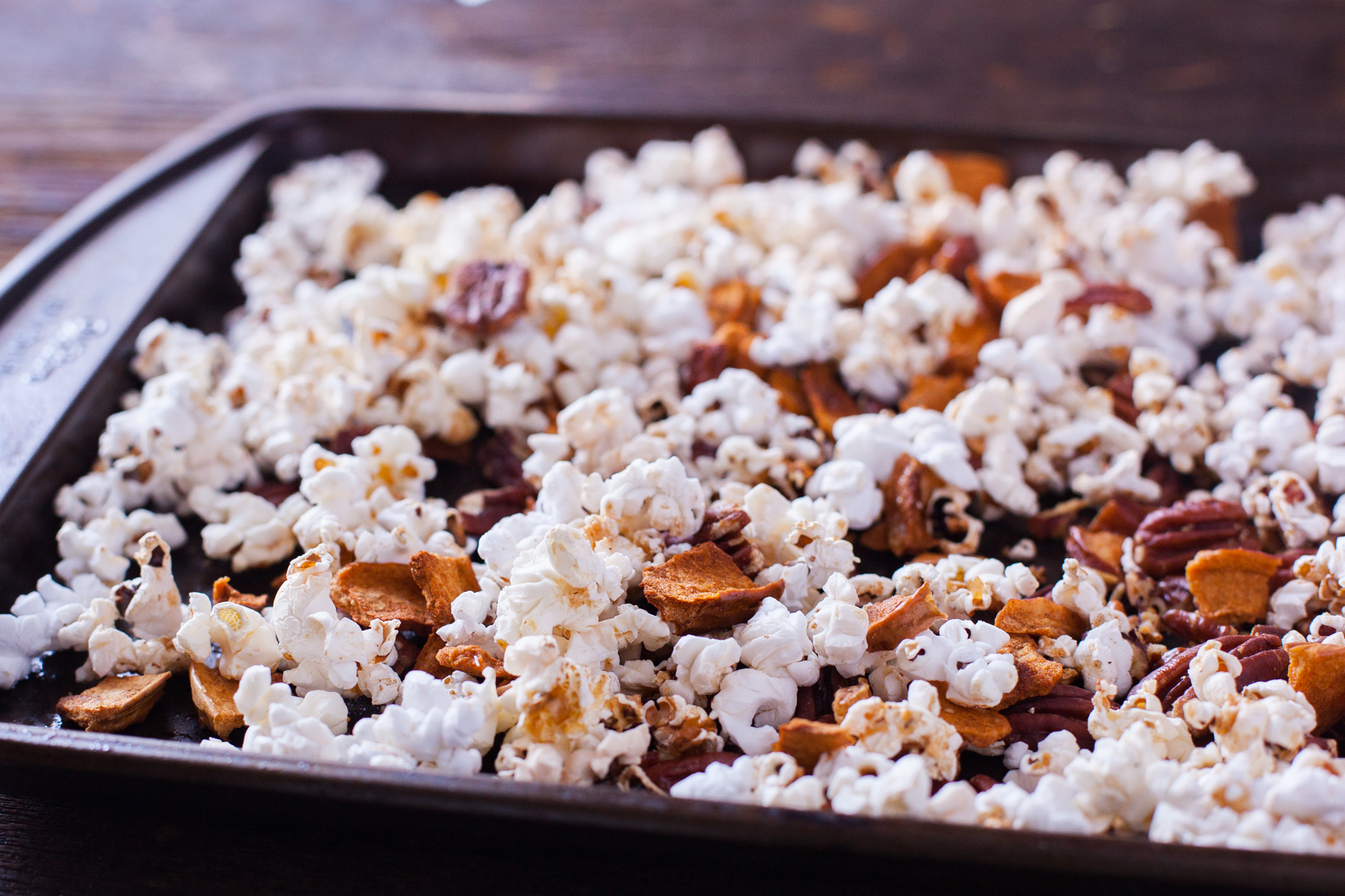 This healthy cinnamon popcorn recipe tosses dried apples, pecans, and air popped popcorn in a light cinnamon butter, for an irresistible snack mix. From EatingRichly.com