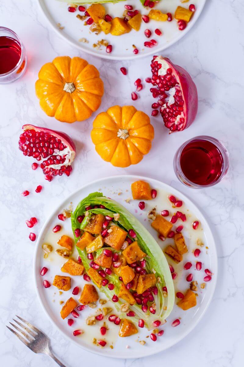 This gorgeous fall wedge salad with romaine is topped with cinnamon roasted butternut squash, pomegranate seeds, and a creamy citrus honey mustard dressing. From EatingRichly.com
