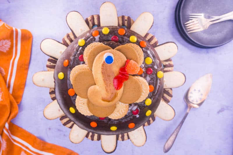 This easy turkey cake is made from a store bought chocolate bundt cake and packaged cookies and candy, so it's no-bake and fast to make! From EatingRichly.com