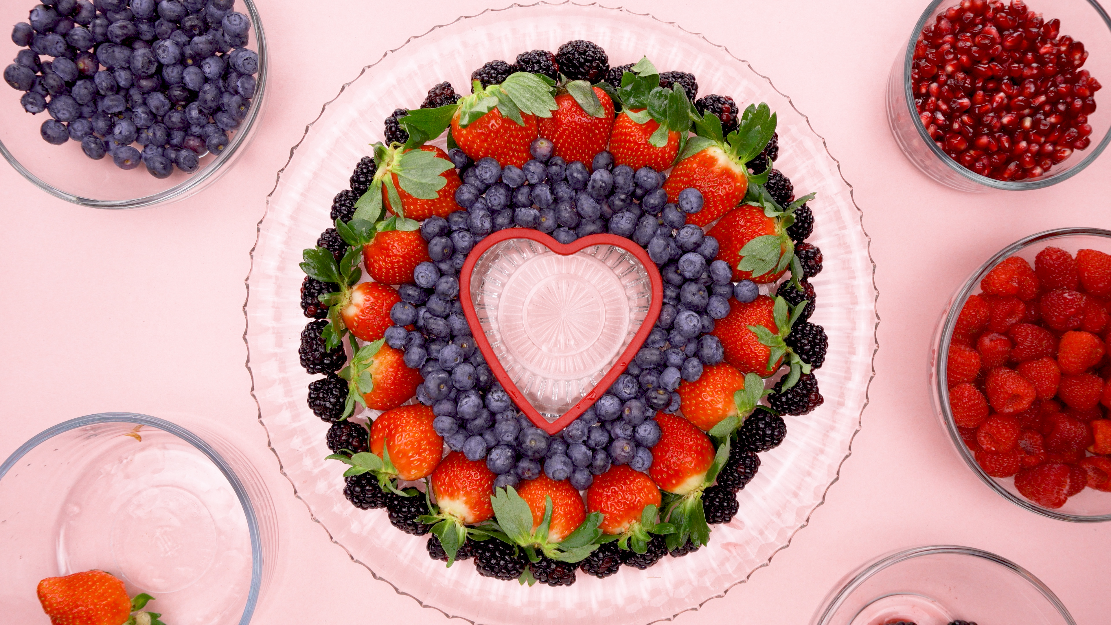 Blackberries Strawberries and blueberries around a heart cookie cutter