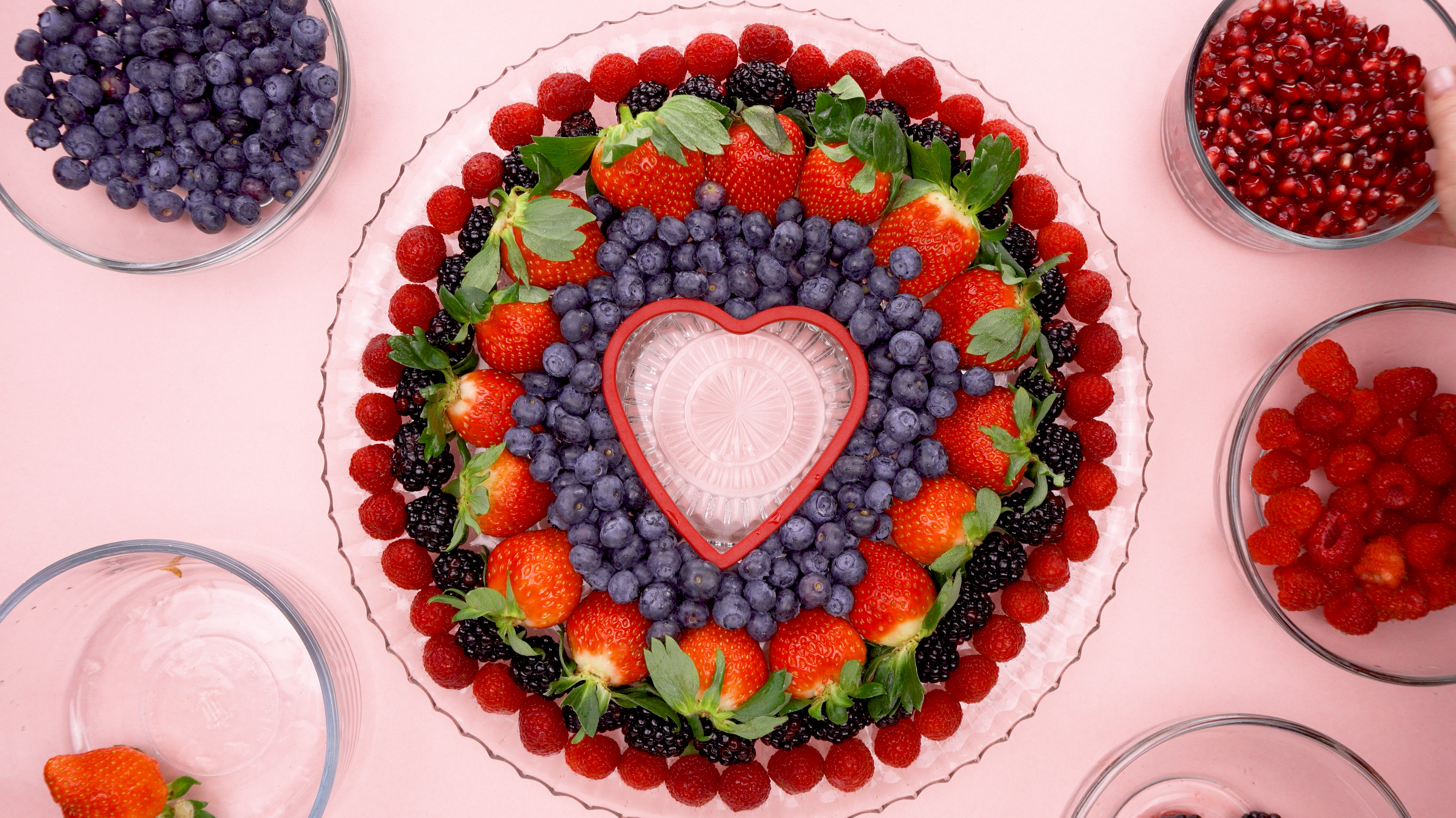 raspberries, Blackberries, Strawberries and blueberries around a heart cookie cutter