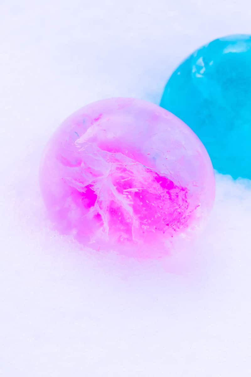 Colorful Frozen Ice Balloon Balls in Snow