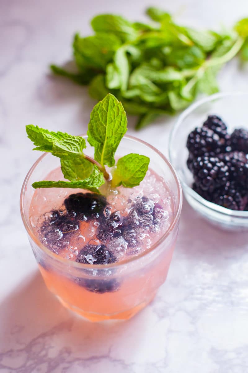 Blackberry Moscow Mule in a glass with blackberries and mint