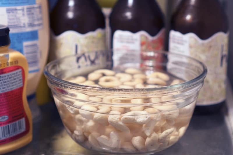 cashews soaking in a bowl of water in the fridge