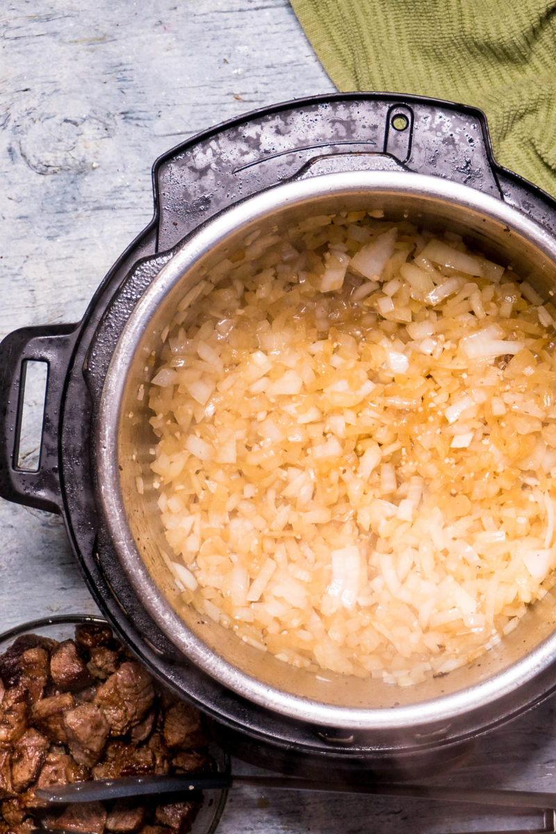 Chopped onions cooking in an Instant Pot